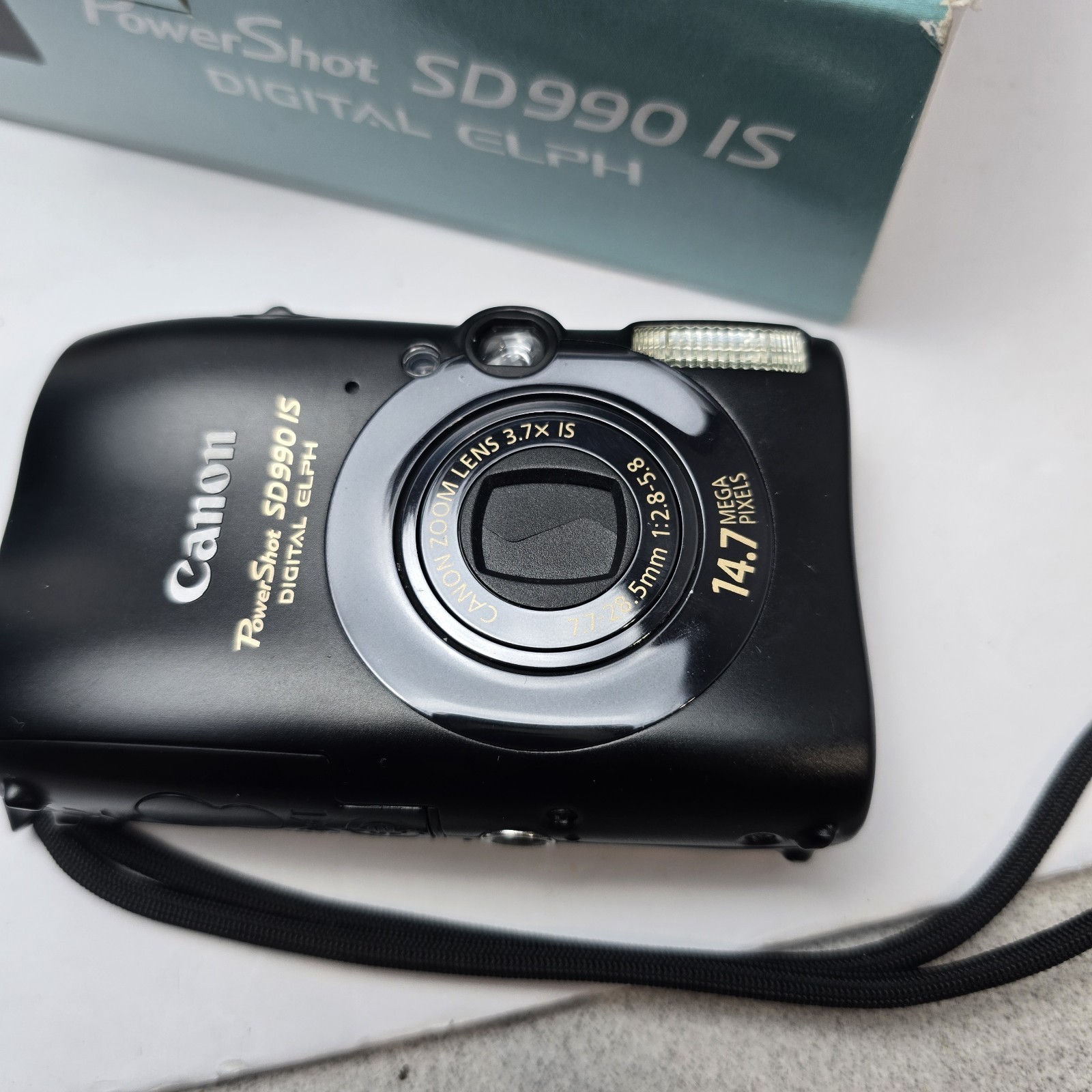 In Box – Canon PowerShot SD990 IS Digital ELPH Camera 14.7 MP 3.7X Zoom Camera